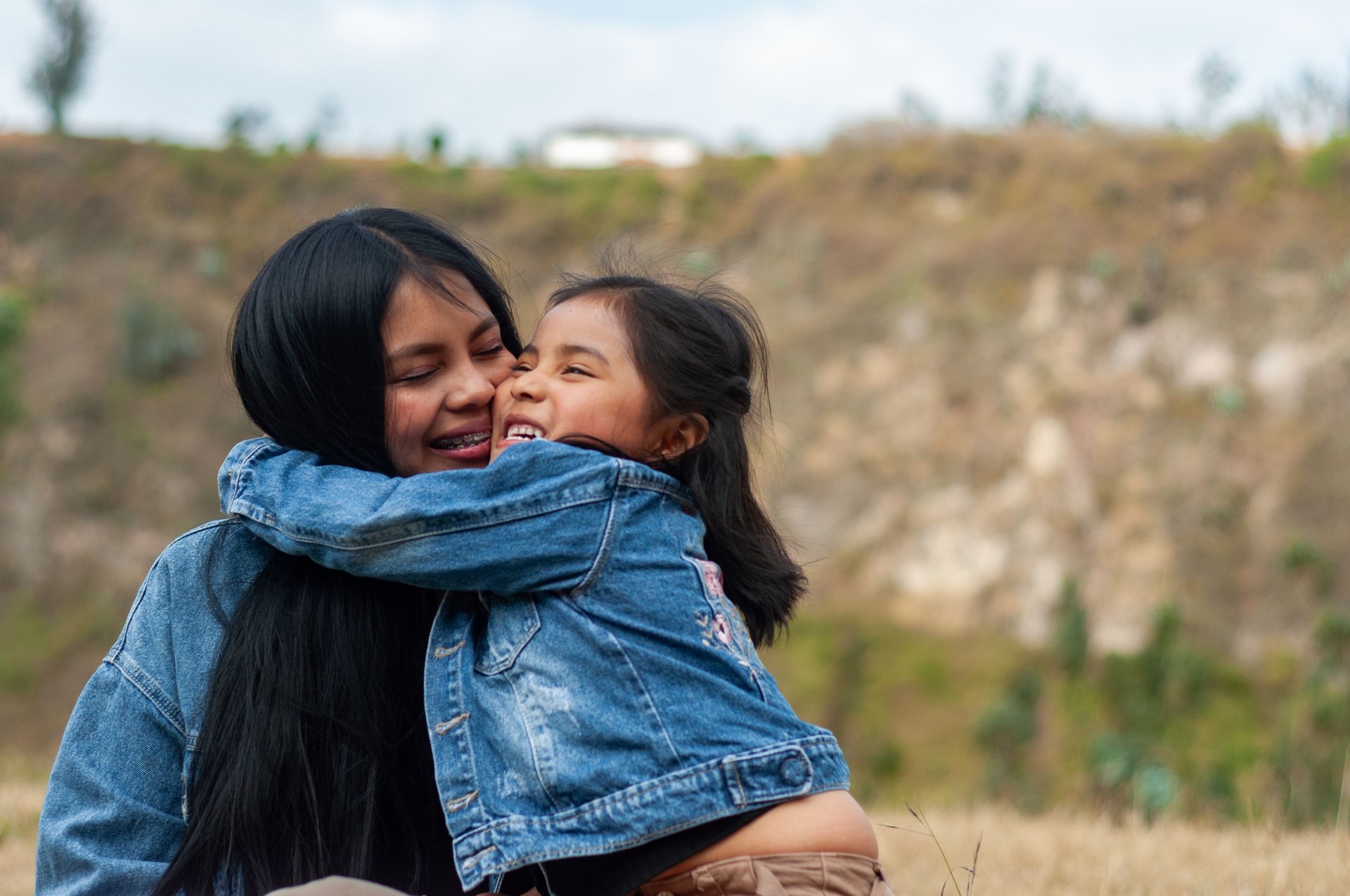 girl and mother hugging each other as a sign of love between them